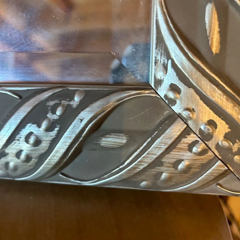 Silver framed mirror with beveled mirror. Good vintage condition.